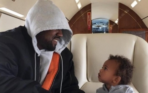 Kanye West Is All Smiles While Helping Son Saint Throw First Pitch at Baseball Game