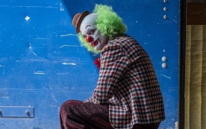 Who Dies? Joaquin Phoenix Is Untypical Mourner in New 'Joker' Set Photos