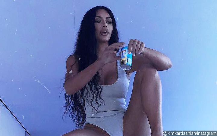 Kim Kardashian Seductively Spreads Her Legs While Sharing