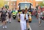 will.i.am Carries Olympics Torch While Tweeting From His Phone