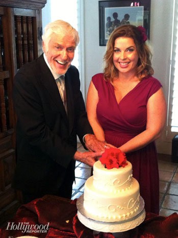  bride Arlene Silver wearing a fuchsia dress as they cut their wedding 