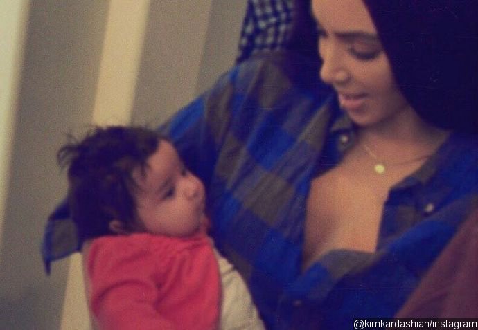 Kim Kardashian Cooing and Holding Baby Dream in New Picture