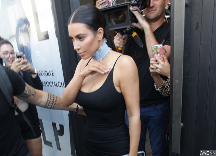 Kim Kardashian Spills Out of Her Skintight LBD