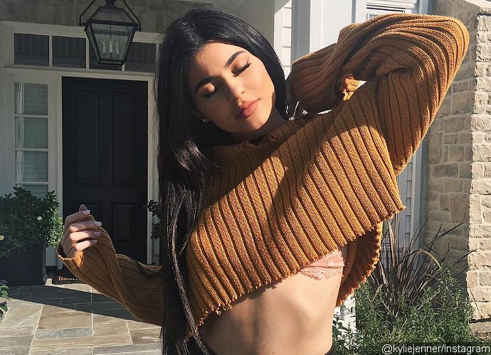Kylie Jenner Shows Off Toned Abs and Flashes Lace Bra in Ripped Crop Top