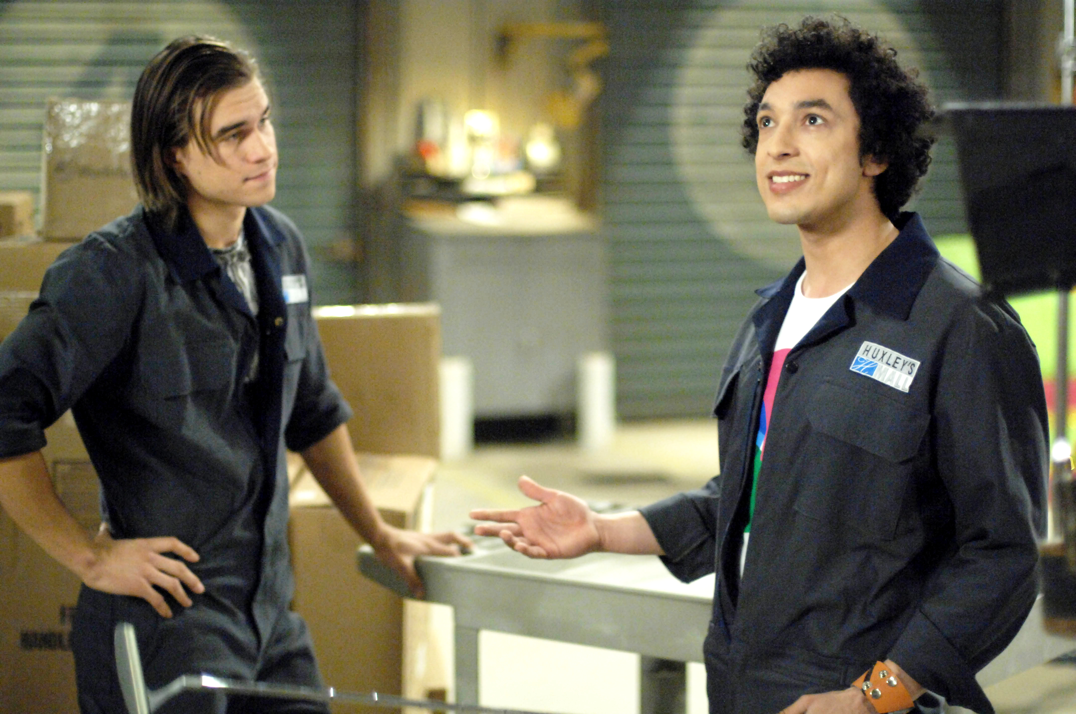 Joey (Rob Mayes) and Ricky (Wade Allain-Marcus) talk in warehouse in The American Mall (2008)