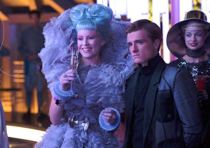 Elizabeth Banks stars as Effie Trinket and Josh Hutcherson stars as Peeta Mellark in Lionsgate Films' The Hunger Games: Catching Fire (2013)