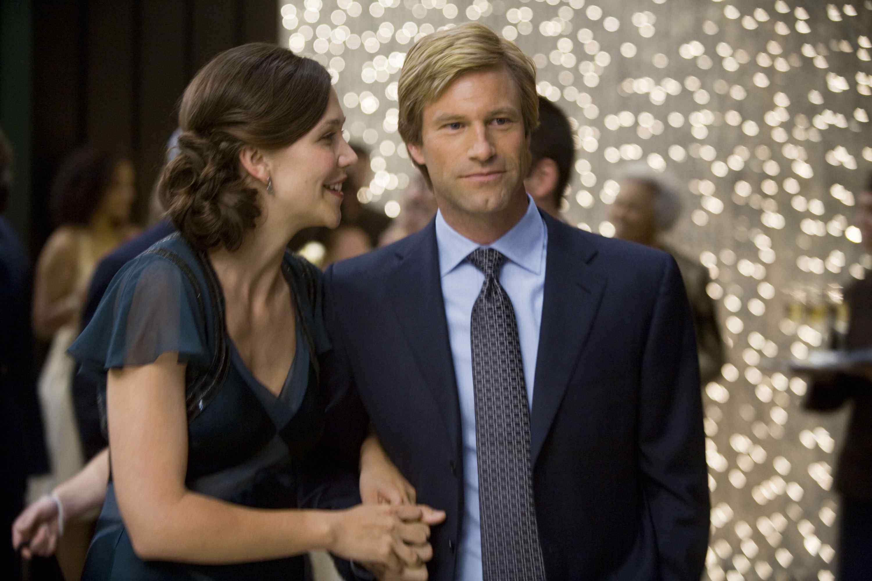 MAGGIE GYLLENHAAL stars as Rachel Dawes and AARON ECKHART stars as Harvey Dent in Warner Bros. Pictures' and Legendary Pictures' action drama 