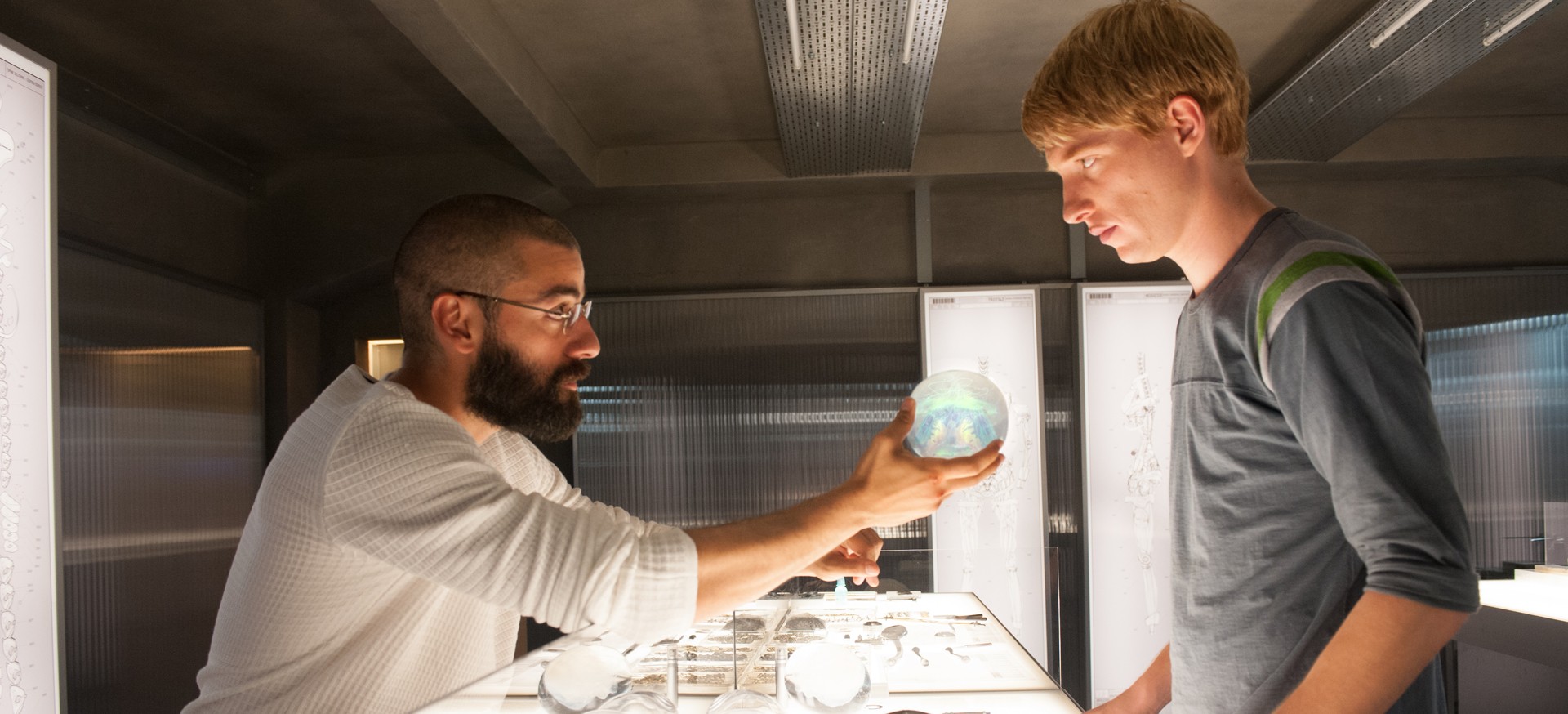 Oscar Isaac stars as Nathan and Domhnall Gleeson stars as Caleb in A24's Ex Machina (2015)