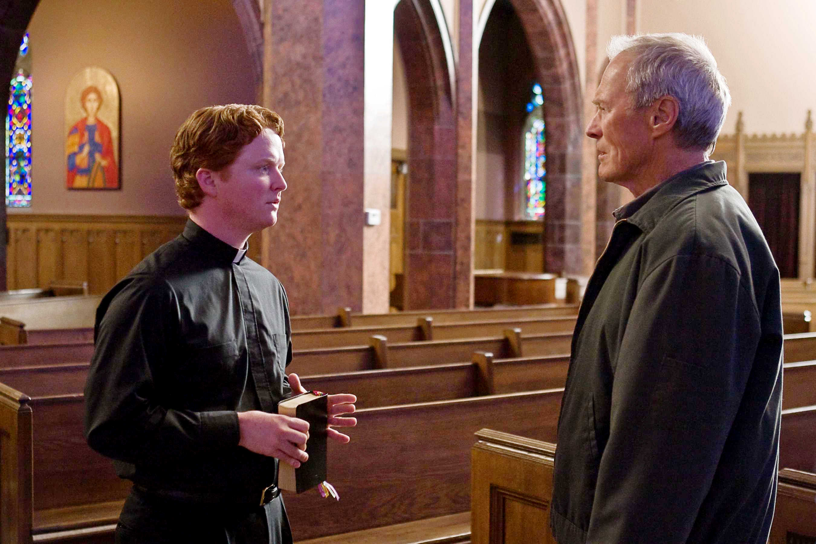 Christopher Carley stars as Father Janovich and Clint Eastwood stars as Walt Kowalski in Warner Bros. Pictures' Gran Torino (2008). Photo credit by Anthony Michael Rivetti.