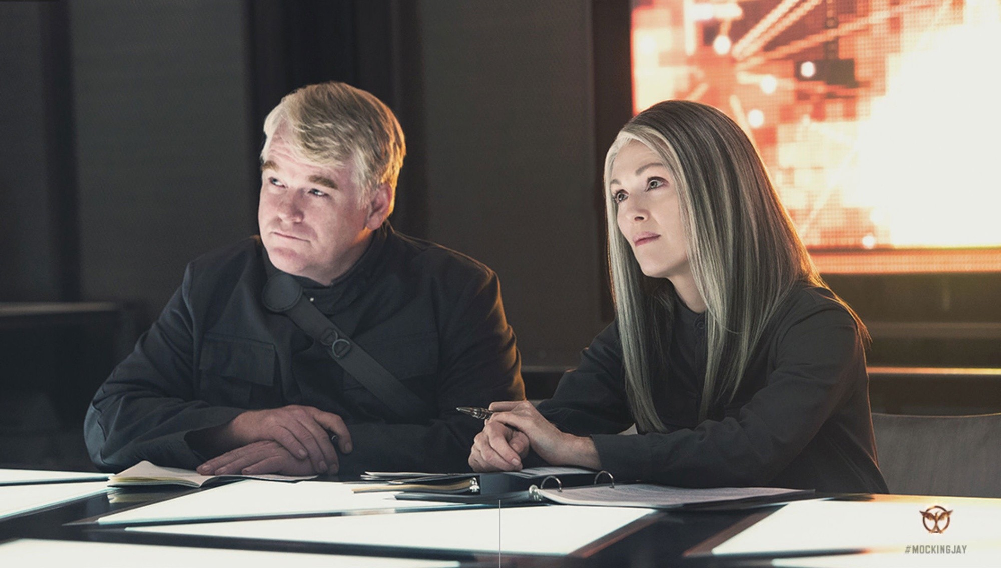 Philip Seymour Hoffman stars as Plutarch Heavensbee and Julianne Moore stars as President Alma Coin in Lionsgate Films' The Hunger Games: Mockingjay, Part 1 (2014)