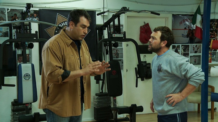 Joe Lo Truglio stars as Officer Fogerty and Rob Riggle stars as James Malone Sr. in Millennium Entertainment's High Road (2012)