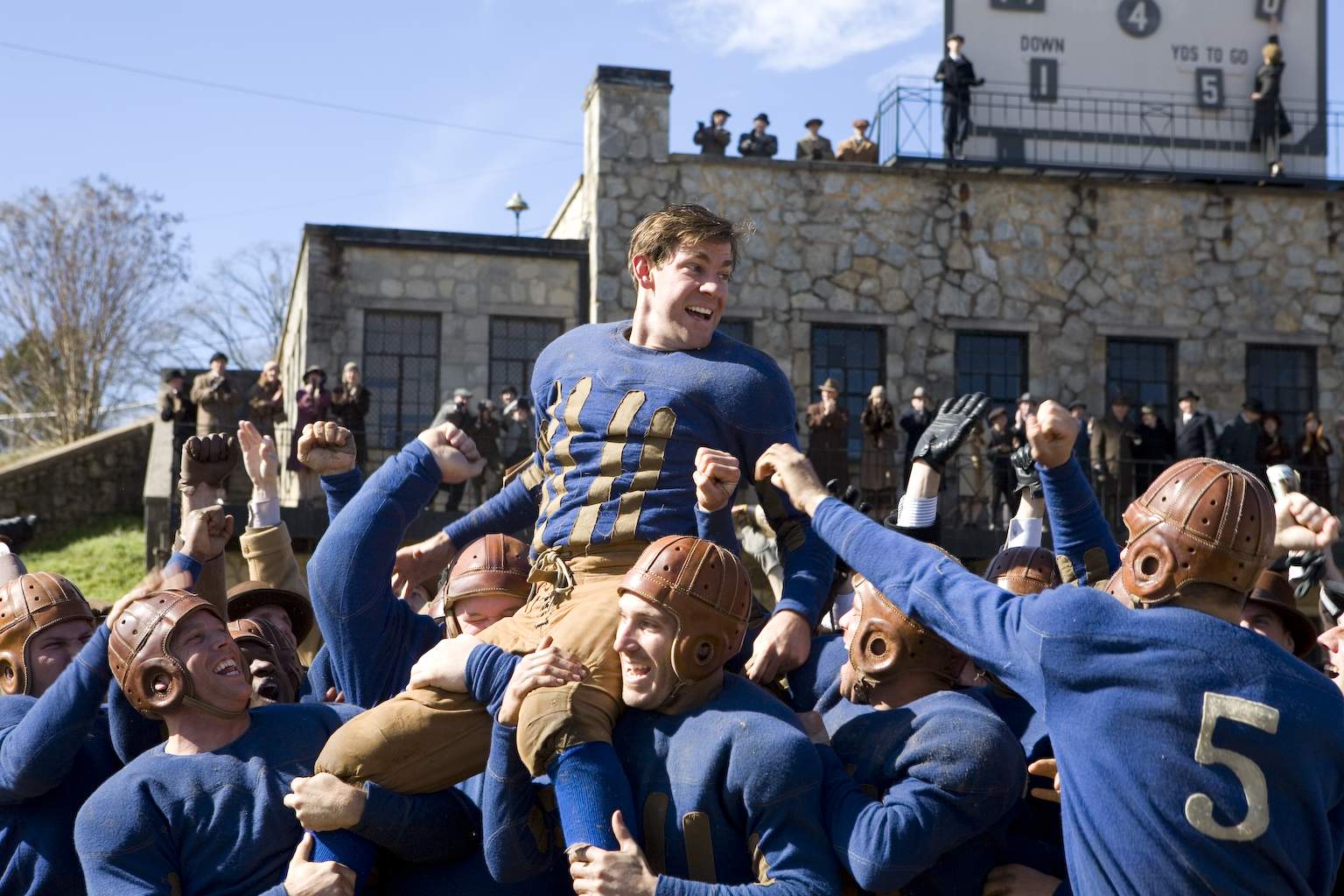 War hero Carter Rutherford (JOHN KRASINSKI) gets carried off the field in Universal Pictures' Leatherheads (2008).