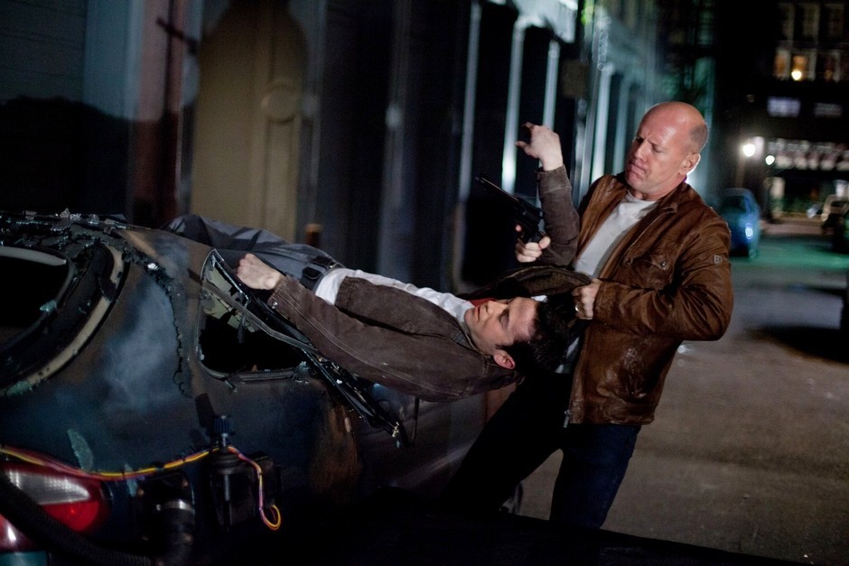 Joseph Gordon-Levitt stars as Joe and Bruce Willis stars as Older Joe in TriStar Pictures' Looper (2012)
