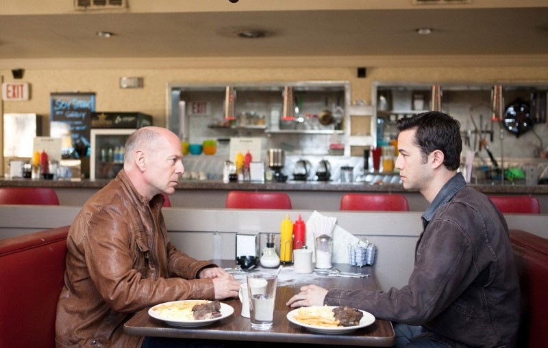 Bruce Willis stars as Older Joe and Joseph Gordon-Levitt stars as Joe in TriStar Pictures' Looper (2012)