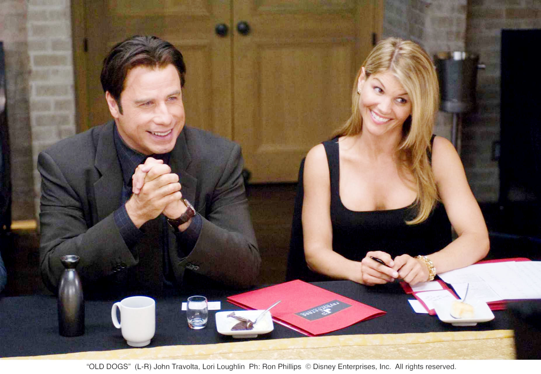 John Travolta (Charlie) and Lori Loughlin in Walt Disney Pictures' Old Dogs (2009). Photo credit by Ron Phillips.