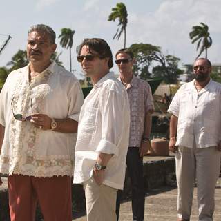 (L-R) General Modrano (JOAQUIN COSIO), Dominic Greene (MATHIEU AMALRIC), Elvis (ANATOLE TAUBMAN),  and Lt. Orso (JESUS OCHOA) meet on the Haitian Quayside. Location: Colon, Panama. Photo by: Karen Ballard.