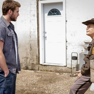 Liam Hemsworth stars as Dwayne McLaren and John Malkovich stars as Sheriff Vogel in A24's Cut Bank (2015)