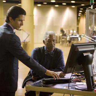 CHRISTIAN BALE stars as Bruce Wayne and MORGAN FREEMAN as Lucius Fox in Warner Bros. Pictures' and Legendary Pictures' action drama 