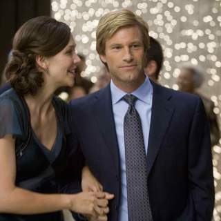 MAGGIE GYLLENHAAL stars as Rachel Dawes and AARON ECKHART stars as Harvey Dent in Warner Bros. Pictures' and Legendary Pictures' action drama 