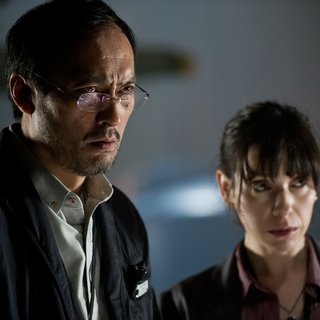 Ken Watanabe stars as Dr. Ichiro Serizawa and Sally Hawkins stars as Vivienne Graham in Warner Bros. Pictures' Godzilla (2014)