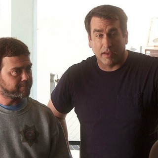 Rob Riggle stars as James Malone Sr. and Joe Lo Truglio stars as Officer Fogerty in Millennium Entertainment's High Road (2012)