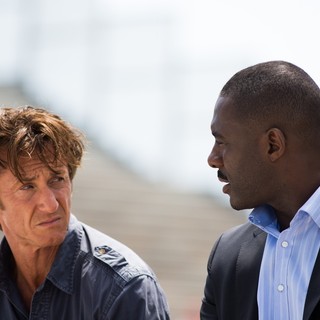 Sean Penn stars as Martin Terrier and Idris Elba stars as DuPont in Open Road Films' The Gunman (2015)