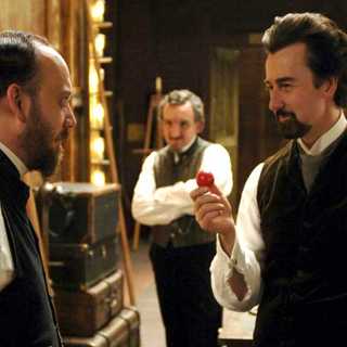 Paul Giamatti as Chief Inspector Uhl and Edward Norton as a magician named Eisenheim in The Illusionist (2006)