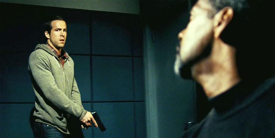 Ryan Reynolds stars as Matt Weston and Denzel Washington stars as Tobin Frost in Universal Pictures' Safe House (2012)
