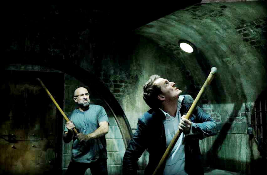 Carlo Rota stars as Charles and Greg Bryk stars as Mallick in Lionsgate Films' Saw V (2008)