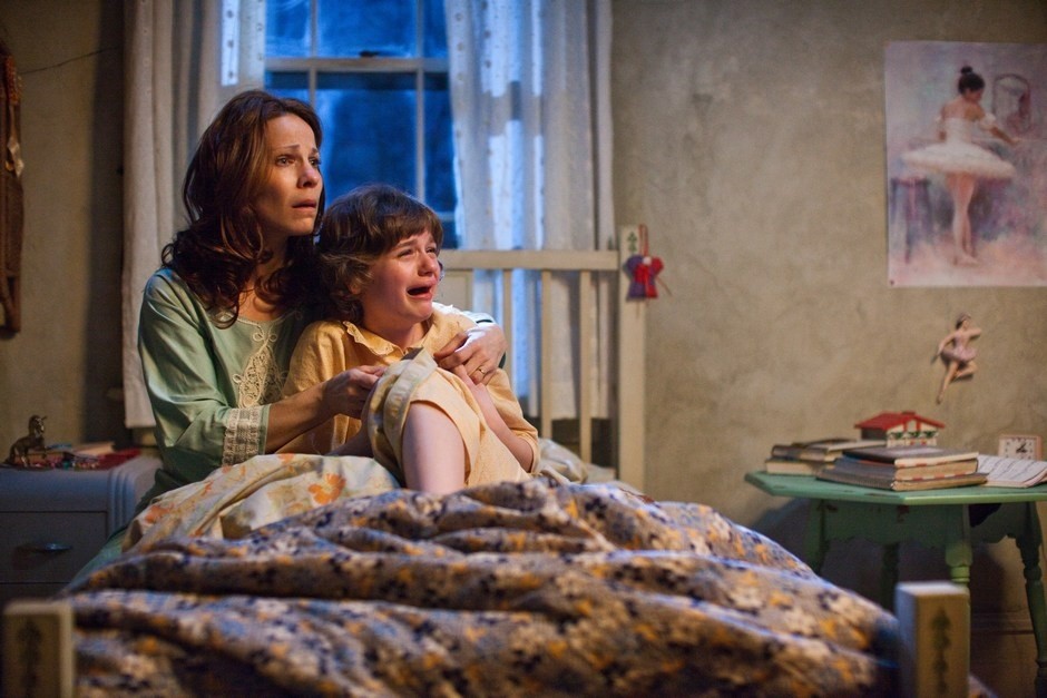 Lili Taylor stars a Carolyn Perron and Joey King stars as Christine in Warner Bros. Pictures' The Conjuring (2013)