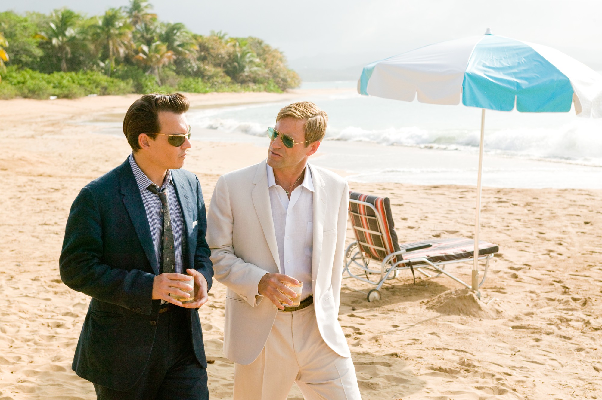 Johnny Depp stars as Paul Kemp and Aaron Eckhart stars as Sanderson in FilmDistrict's The Rum Diary (2011)