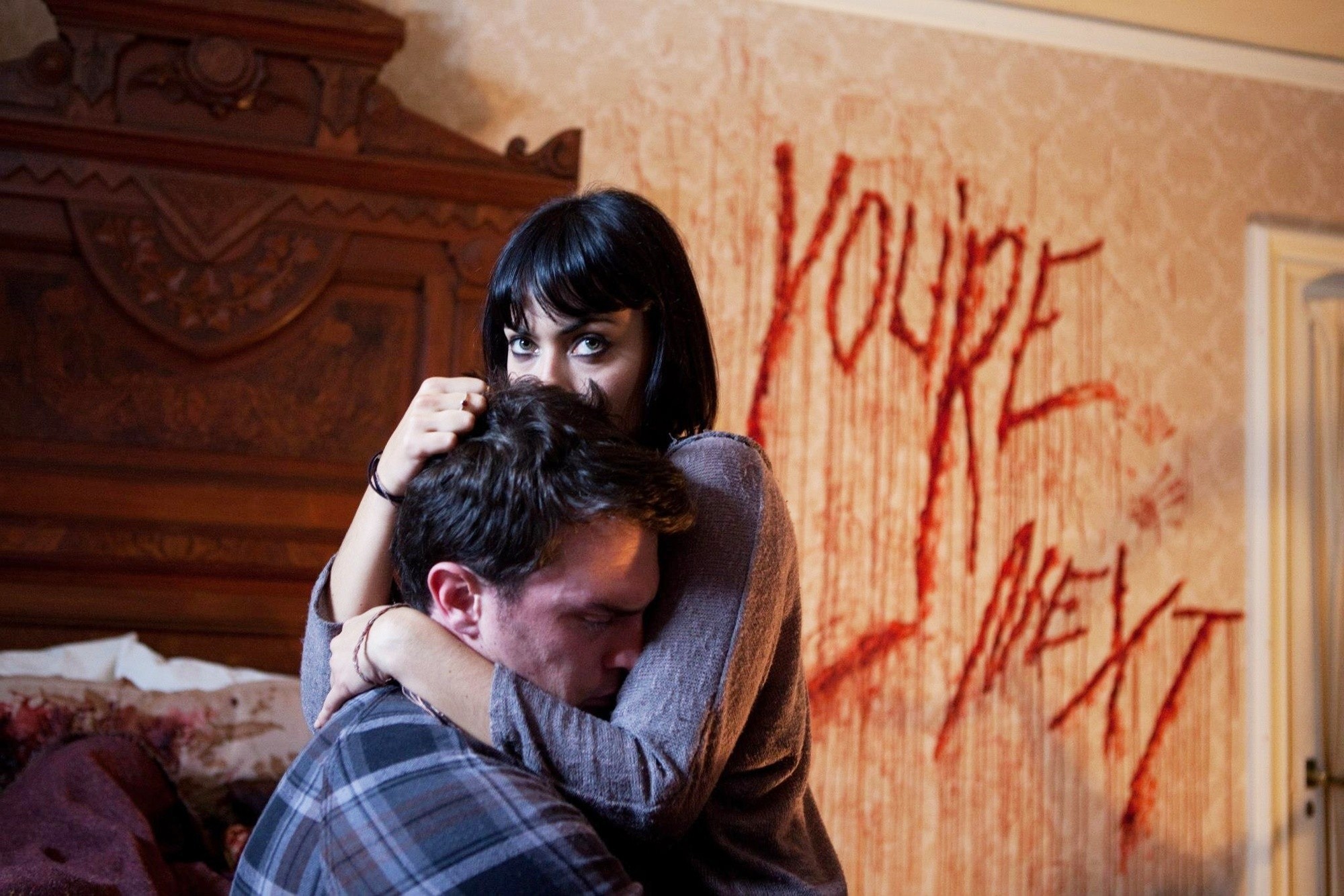 Joe Swanberg stars as Drake and Wendy Glenn stars as Zee in Lionsgate Films' You're Next (2013)