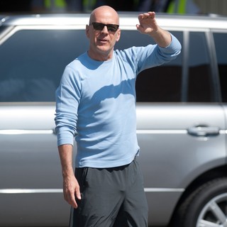 Bruce Willis in Bruce Willis Waves to Fans at Budapest Airport as He Arrives in The Hungarian Capital
