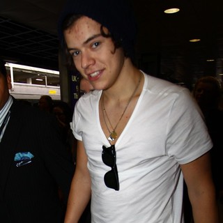 Harry Styles, One Direction in One Direction Arrive at Heathrow Airport