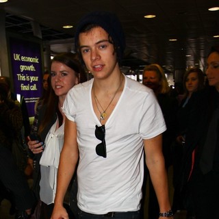 Harry Styles, One Direction in One Direction Arrive at Heathrow Airport