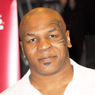 Mike Tyson in Mike Tyson signing copies of the Blu-ray and DVD 'Tyson'