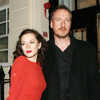 Anna Friel in a stunning scarlet dress, leaves the Theatre Royal