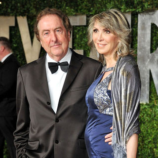 Eric Idle, Tania Kosevich in 2011 Vanity Fair Oscar Party - Arrivals