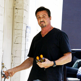Sylvester Stallone in Sylvester Stallone poses for photographs as he arrives at a building