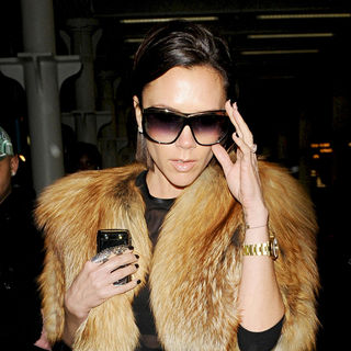 Victoria Adams in Victoria Beckham arriving in London while wearing a see-through black top