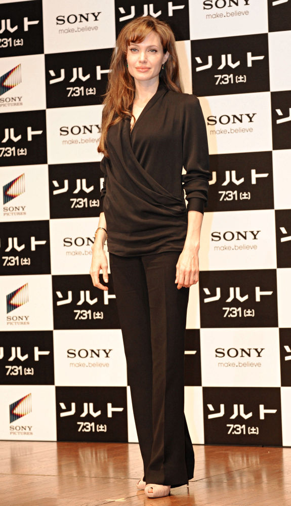 © Sean Brophy/Hottwire.net/WENN
            
           This week, Star Magazine has published shocking image of Angelina Jolie who is currently busy promoting her new movie "Salt". The mag outed the shot, which was taken from an unauthorized biography by Andrew Morton which is due for release in August, showing Jolie flashing her breasts. 
The risque picture, however, shows Jolie not only getting naked but also having peculiar thing attached to her body.