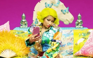 Nicki Minaj Sports Neon Yellow Wig in BTS' Alternate 'IDOL' Music Video