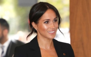 Meghan Markle Craddles Growing Baby Bump in Stunning Blue Gown in Fiji