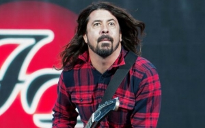 Dave Grohl Takes a Tumble Off Stage After Downing a Can of Beer
