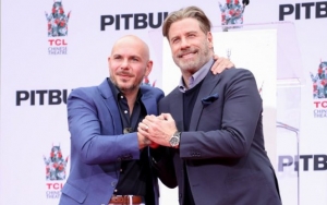John Travolta Names Pitbull as Inspiration for His Bald Look