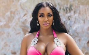 Porsha Williams Soaks Up the Sun While Baring Her Baby Bump in Fuschia Bikini