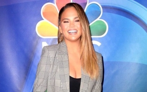 Chrissy Teigen Blames Water Slide Oil for Massive Bruises on Leg