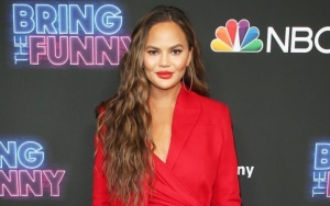 Chrissy Teigen's Boobs Almost Spill Out of Her Deep-Plunging Swimsuit