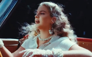 Lana Del Rey Features Controversial Mesh Mask in 'Chemtrails Over the Country Club' Music Video