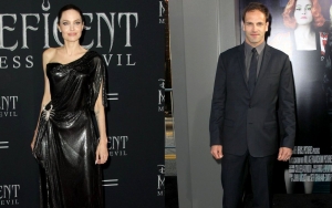 Angelina Jolie Brings a Bottle of Wine While Visiting Ex Jonny Lee Miller's NYC Apartment 
